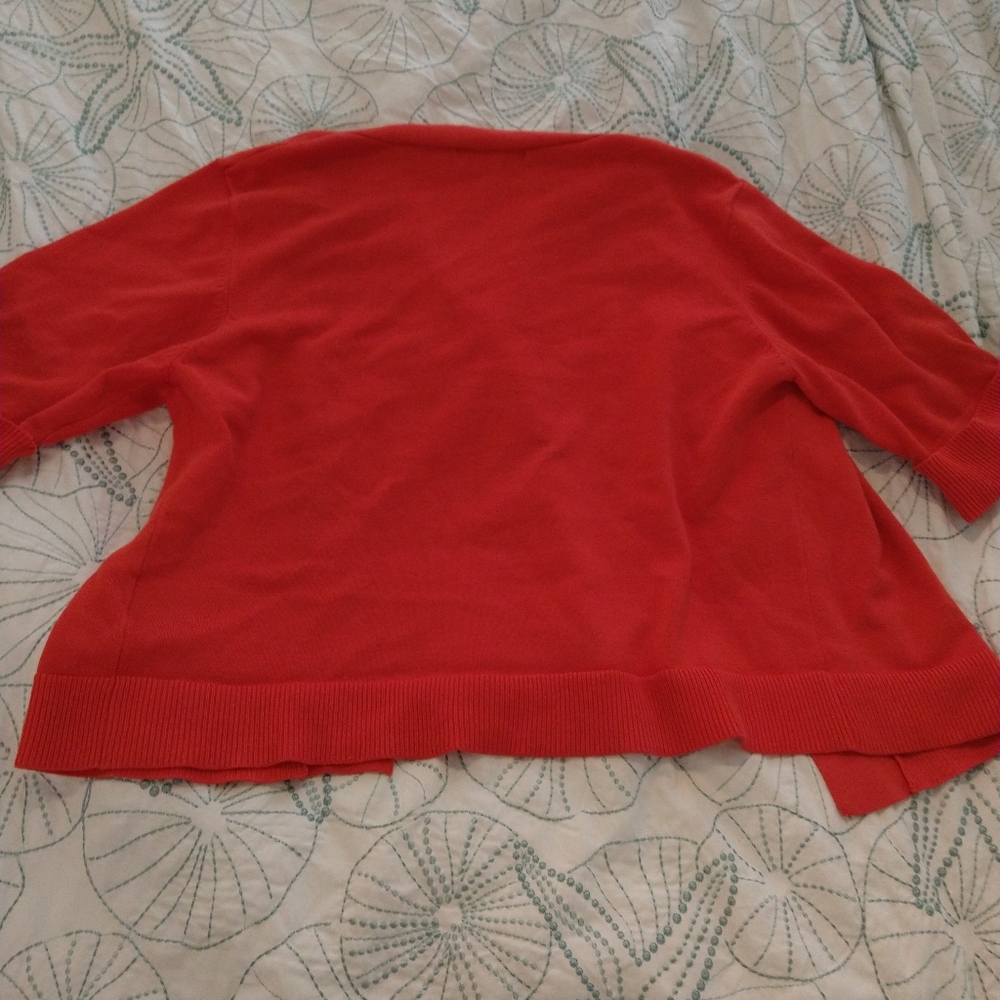 A women's lage vest. Color is bright red.The brand is 89th and Madison.